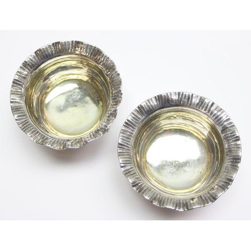 1032 - A pair of early Victorian cast silver salts with frilled rims and gilt interiors, London 1860 by Joh... 