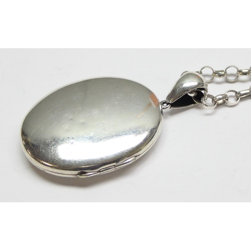 1146 - A large antique silver locket on a modern 925 silver chain, the locket seemingly unmarked but XRF te... 