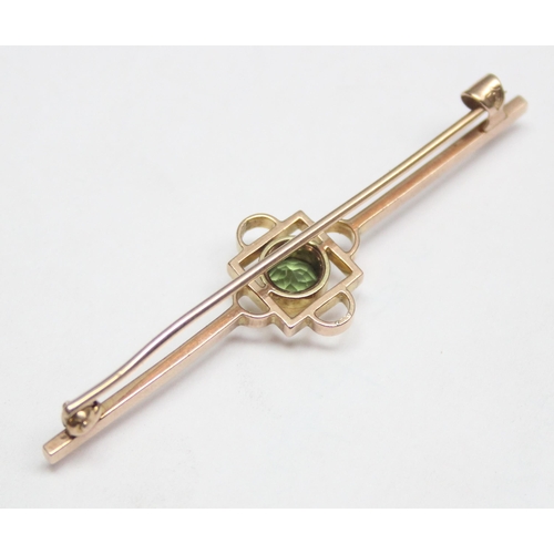 1148 - An antique 9ct gold bar brooch set with Peridot, seemingly unmarked but XRF tests as 9ct gold, appro... 