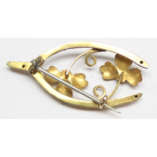 1150 - An Art Nouveau period 9ct gold wishbone brooch set with garnets (sic Sapphires), approx 2.02g gross