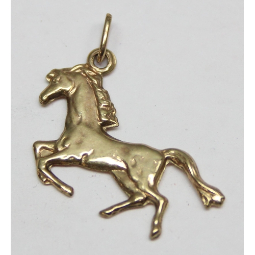 1153 - A 9ct gold charm formed as a horse, approx 0.53g gross