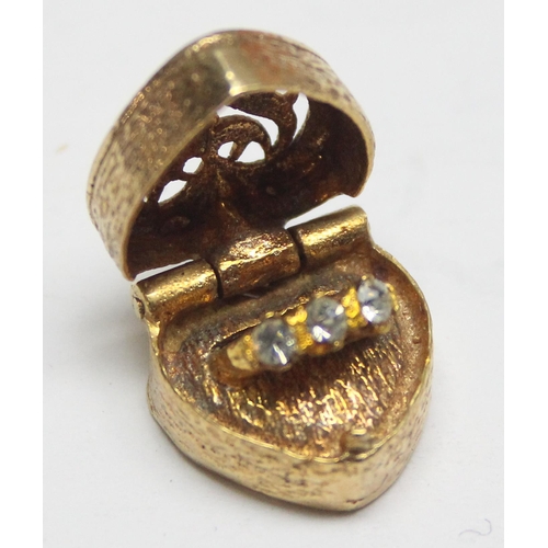 1157 - 9ct gold charm formed as a pierced heart shaped box containing a miniature engagement ring, approx 5... 