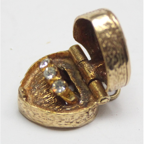 1157 - 9ct gold charm formed as a pierced heart shaped box containing a miniature engagement ring, approx 5... 