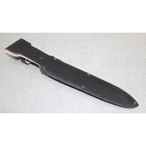 1450 - Large survival knife in sheath, blade measures approx. 25cm