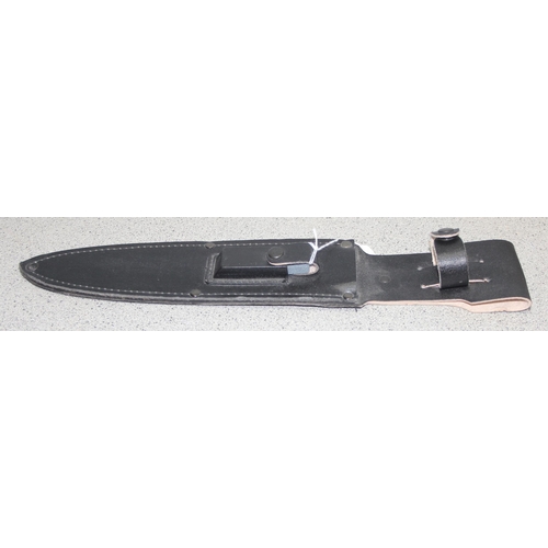 1450 - Large survival knife in sheath, blade measures approx. 25cm