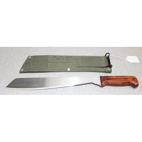 1451 - British Army machete in sheath, blade measures approx. 33cm