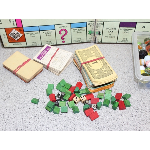 1500 - Qty of glass marbles and a vintage monopoly set (unboxed)