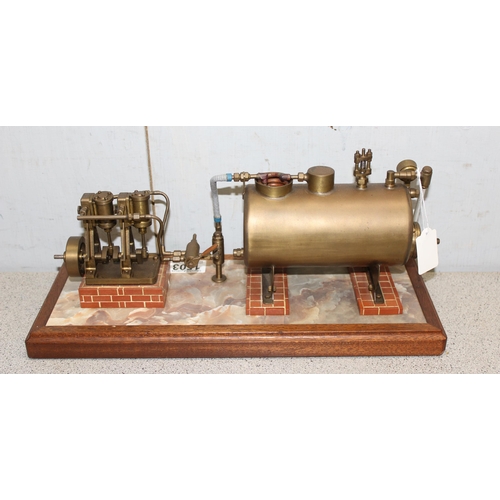 1503 - A well engineered model of a twin oscillating vertical steam engine, linked to a brass horizontal cr... 