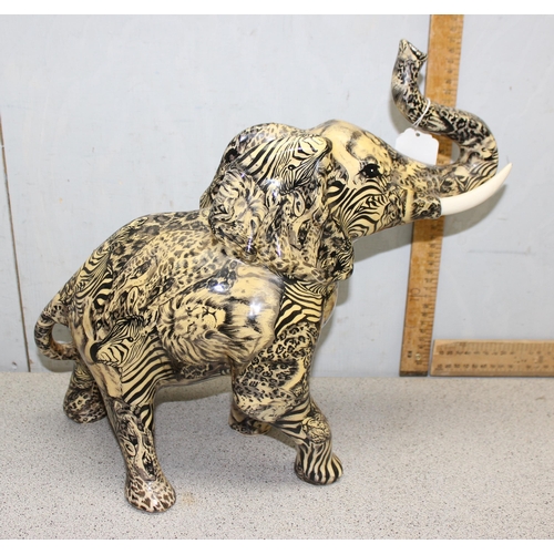 1703 - Pottery elephant with African animal pattern design