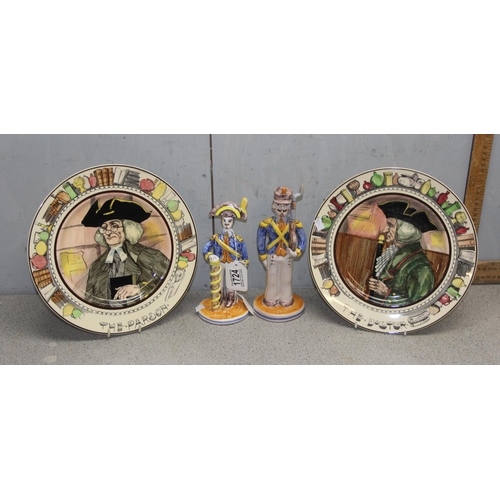 1724 - A pair of Royal Doulton series ware plates and a pair of Spanish faience style figures of soldiers, ... 