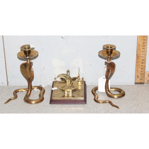 1725 - A pair of brass candlesticks formed as Cobra snakes and a reproduction brass sextant or sundial