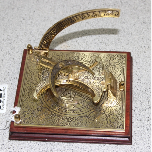 1725 - A pair of brass candlesticks formed as Cobra snakes and a reproduction brass sextant or sundial