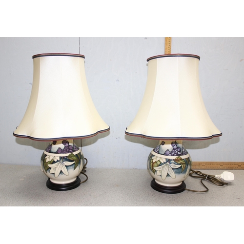 238 - A large pair of Moorcroft table lamps in the Juneberry pattern, with shades and a further pair of ne... 