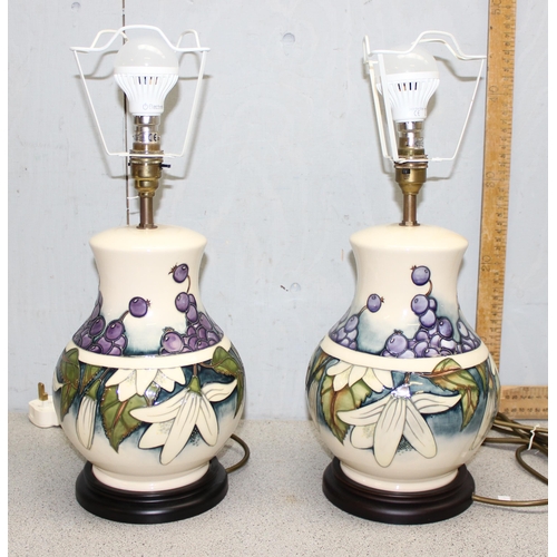 238 - A large pair of Moorcroft table lamps in the Juneberry pattern, with shades and a further pair of ne... 