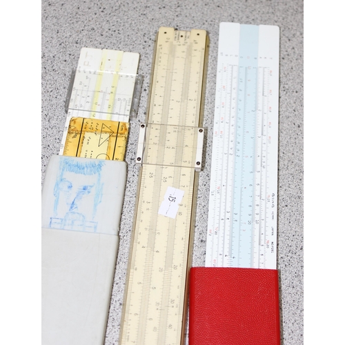 652 - Vintage measuring equipment to include a 30ft cloth tape measure and 3 slide rules