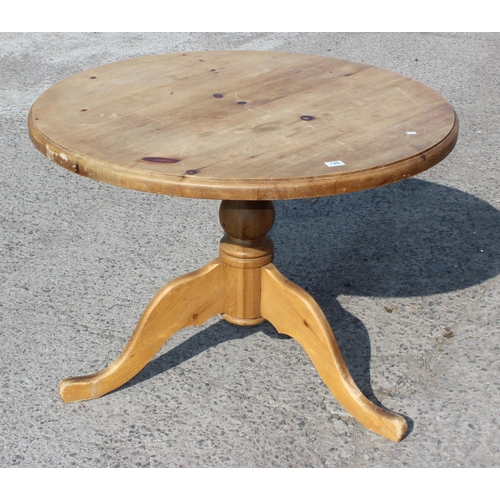 149 - Round pine kitchen table on three-legged base approx 110cm in diameter, 78cm high