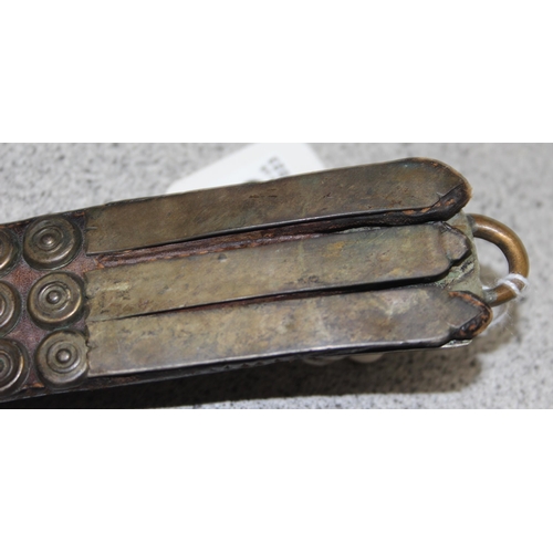 1648 - An unusual antique studded leather belt set with cabochon bloodstones, the unmarked white metal moun... 