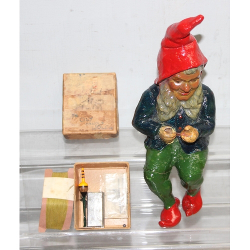 301 - A vintage painted ceramic garden gnome with various fishing related accessories, very well modelled,... 