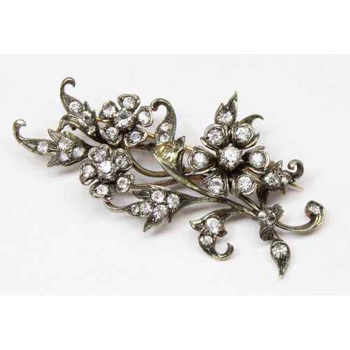 1163 - An 800 silver brooch formed as a branch set with white stones, and a 925 silver bracelet with padloc... 