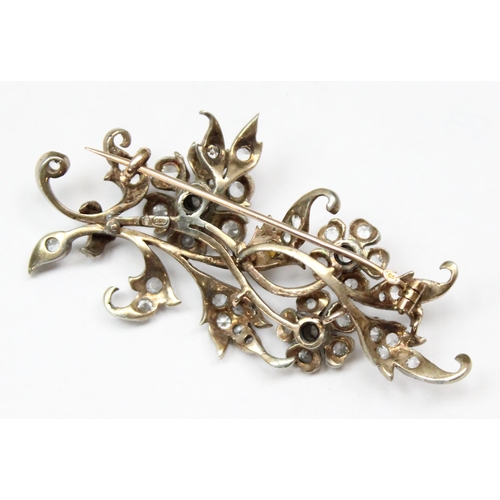 1163 - An 800 silver brooch formed as a branch set with white stones, and a 925 silver bracelet with padloc... 