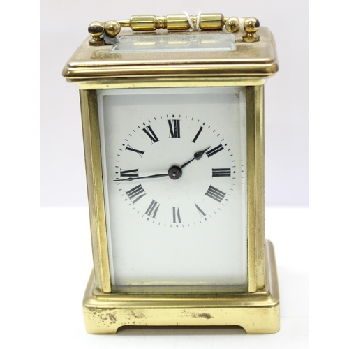 1322 - An antique French made brass cased carriage clock and key with dedication