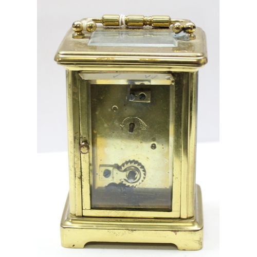 1322 - An antique French made brass cased carriage clock and key with dedication