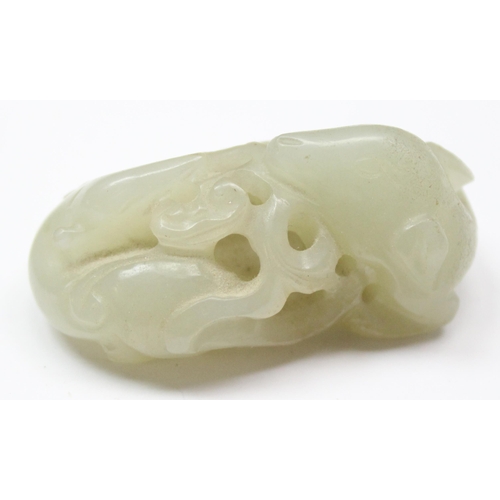 1609 - A small Chinese jade carving depicting 2 entwined mythical beasts, on wooden stand, approx 46mm wide... 