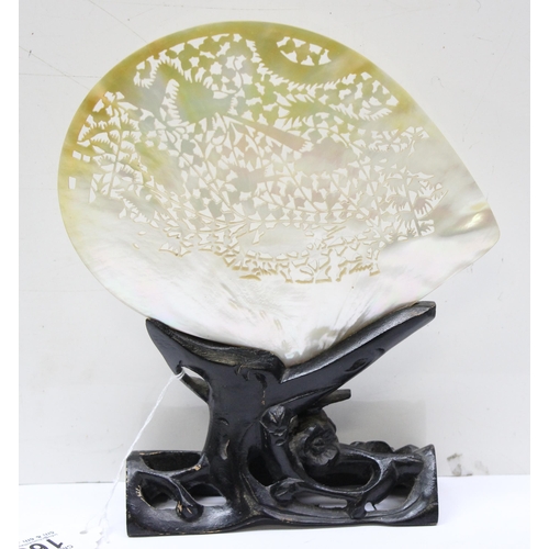 1655 - A Chinese carved mother of pearl shell with pierced decoration, on wooden stand, approx 20cm wide, l... 