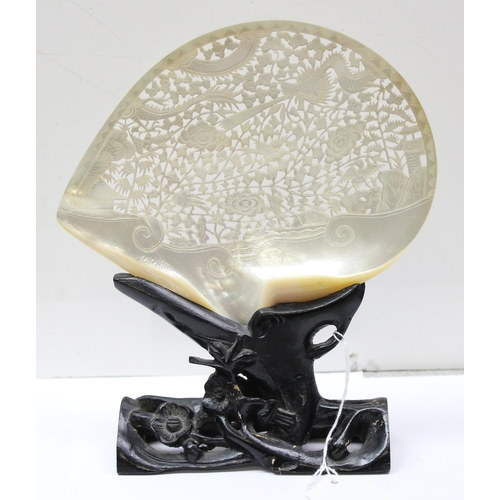 1655 - A Chinese carved mother of pearl shell with pierced decoration, on wooden stand, approx 20cm wide, l... 