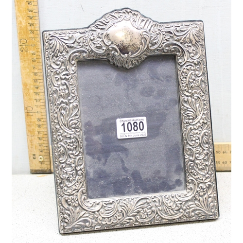 1080 - A large antique style embossed silver photograph frame, London 2000 by JC, approx 29cm x 21cm