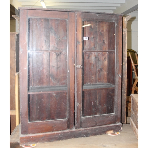 102 - An antique stained pine glazed bookcase, approx 95cm wide