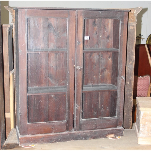 102 - An antique stained pine glazed bookcase, approx 95cm wide