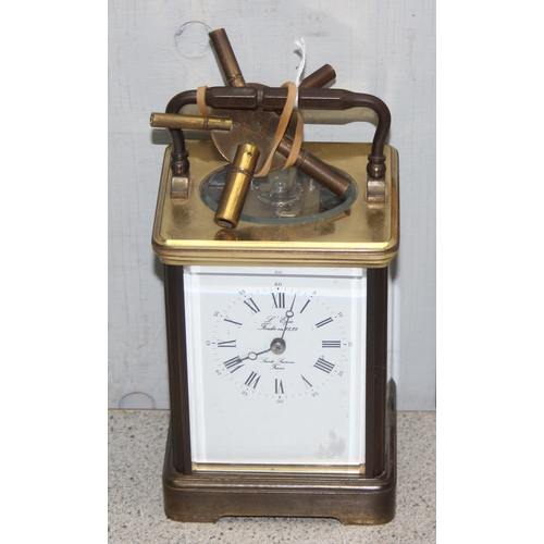 1330 - A vintage L' Epee French gilt brass carriage clock of square shape, the enamel dial with Arabic and ... 