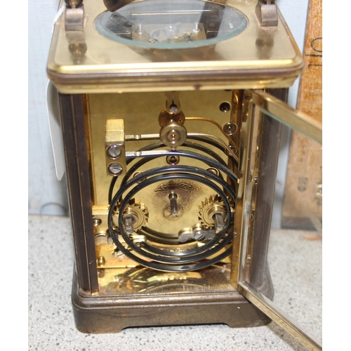 1330 - A vintage L' Epee French gilt brass carriage clock of square shape, the enamel dial with Arabic and ... 