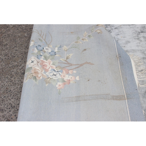 202 - A large silver coloured flower rug, approx 370cm x 276cm