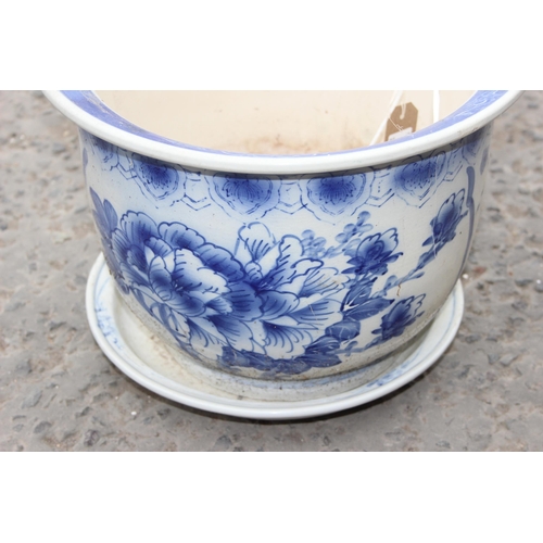 344 - A Chinese style blue and white garden pot with stand, approx 38cm in diameter