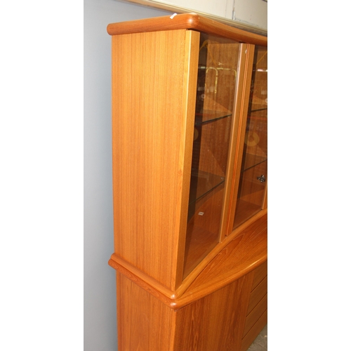 36A - A large Danish display cabinet by Preben Schou, 2 cupboards flanking 3 drawers and a glazed removabl... 