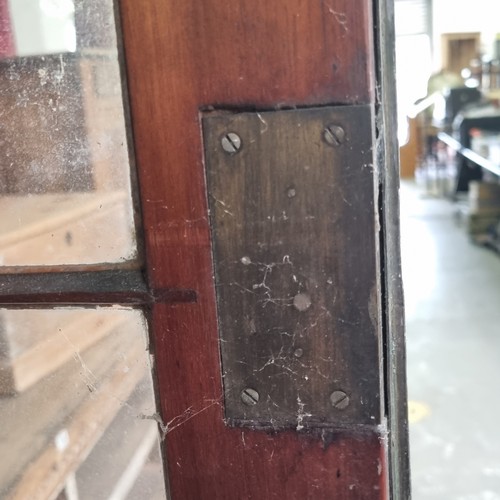 109 - A large 19th century mahogany glazed bookcase with cupboard base, approx 220cm tall x 158cm wide