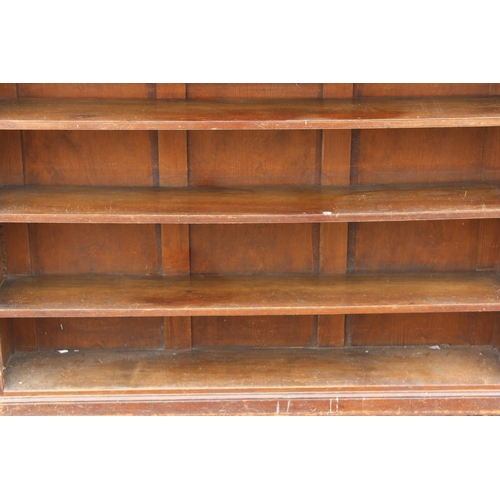 32 - An antique stained pine bookcase with 3 adjustable shelves, approx 160cm wide x 118cm tall x 33cm de... 