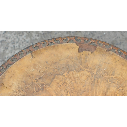 38 - A 19th century walnut wine table with carved base and marquetry inlay, approx 50cm in diameter