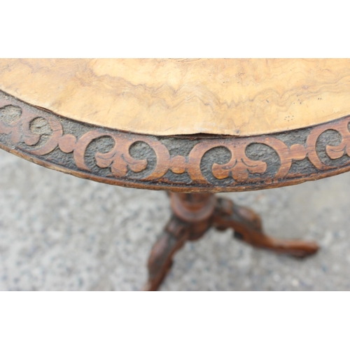 38 - A 19th century walnut wine table with carved base and marquetry inlay, approx 50cm in diameter