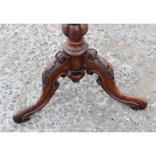 38 - A 19th century walnut wine table with carved base and marquetry inlay, approx 50cm in diameter