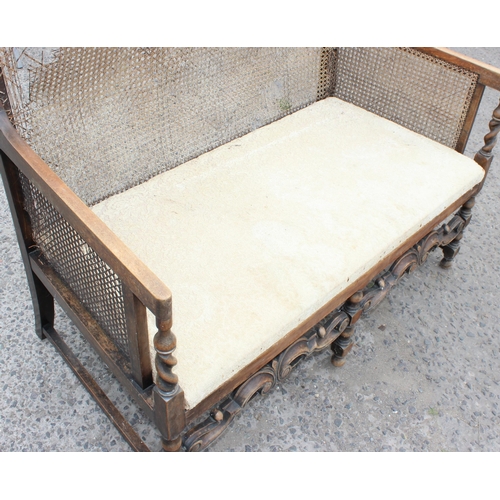 24 - A Charles II style bergere backed love seat or bench, likely c.1930, approx 117cm wide x 92cm tall x... 