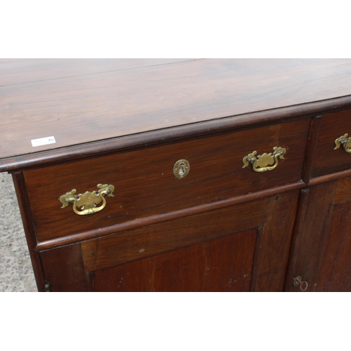 35 - A 19th century mahogany sideboard with 2 drawers over 2 cupboards and brass fittings, approx 126cm w... 