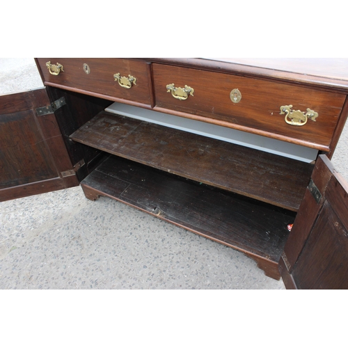 35 - A 19th century mahogany sideboard with 2 drawers over 2 cupboards and brass fittings, approx 126cm w... 