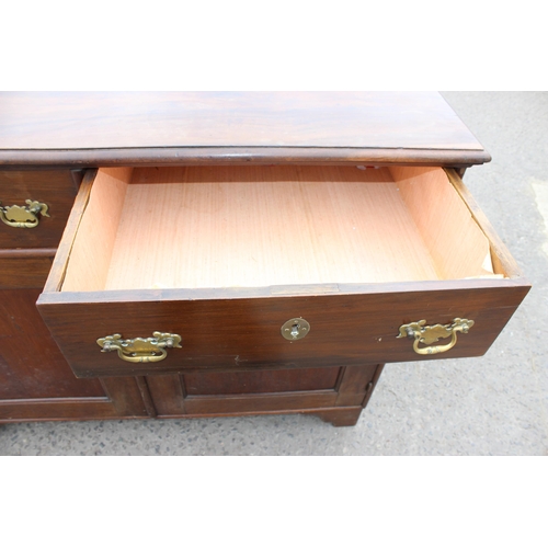 35 - A 19th century mahogany sideboard with 2 drawers over 2 cupboards and brass fittings, approx 126cm w... 