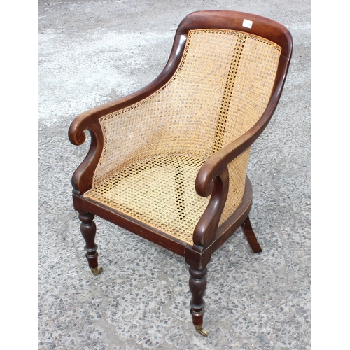 36 - A Regency or William IV period mahogany framed and Bergere seated library chair