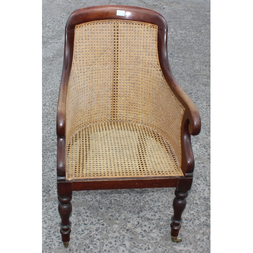 36 - A Regency or William IV period mahogany framed and Bergere seated library chair