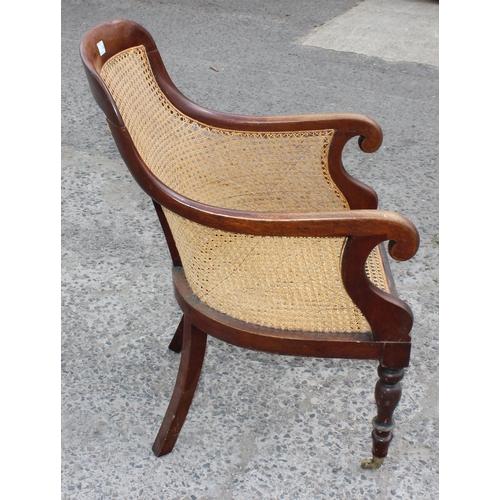 36 - A Regency or William IV period mahogany framed and Bergere seated library chair