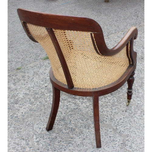 36 - A Regency or William IV period mahogany framed and Bergere seated library chair